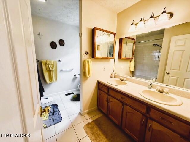 15 Felix Ct, Crossville, TN 38558 - full bath with tiled shower, double vanity, tile patterned floors, toilet, and baseboards