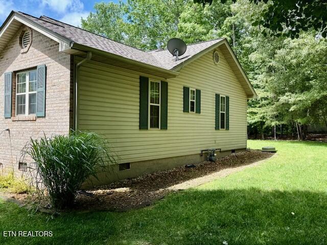 15 Felix Ct, Crossville, TN 38558 - view of home's exterior featuring crawl space, a yard, roof with shingles, and brick siding