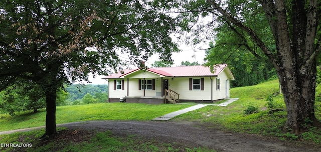 550 N 13th St, Lafollette, TN 37766 - ranch-style home with a front yard and metal roof