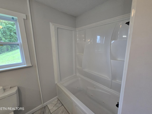 550 N 13th St, Lafollette, TN 37766 - bathroom with marble look tile flooring, toilet, a combined bath / shower with jetted tub, and baseboards