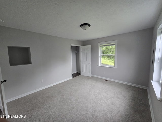 550 N 13th St, Lafollette, TN 37766 - unfurnished bedroom with carpet, baseboards, and a textured ceiling