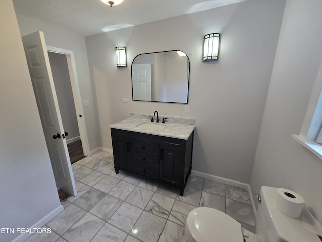 550 N 13th St, Lafollette, TN 37766 - bathroom featuring marble look tile flooring, vanity, toilet, and baseboards