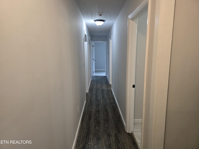 550 N 13th St, Lafollette, TN 37766 - hall featuring dark wood-type flooring, baseboards, and a textured ceiling