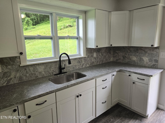 550 N 13th St, Lafollette, TN 37766 - kitchen with a sink, white cabinets, dark wood-type flooring, and tasteful backsplash