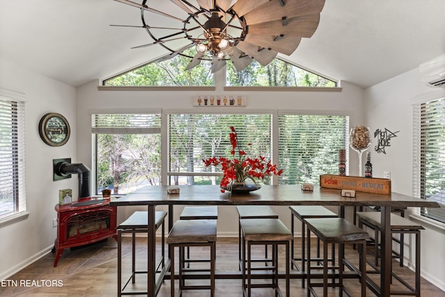 407 Tecumseh Pt, Loudon, TN 37774 - dining room with vaulted ceiling, a wood stove, healthy amount of natural light, baseboards, and ceiling fan