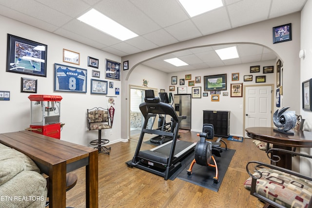 407 Tecumseh Pt, Loudon, TN 37774 - workout room featuring arched walkways, a paneled ceiling, wood finished floors, and baseboards