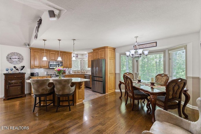 407 Tecumseh Pt, Loudon, TN 37774 - dining space featuring a chandelier, dark wood-type flooring, baseboards, and a textured ceiling