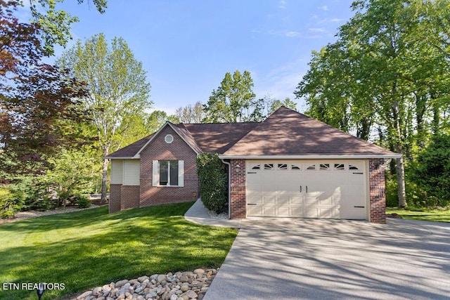 407 Tecumseh Pt, Loudon, TN 37774 - single story home featuring brick siding, driveway, a front lawn, and an attached garage