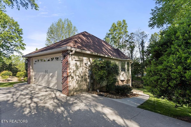 407 Tecumseh Pt, Loudon, TN 37774 - view of side of property featuring concrete driveway, brick siding, and an attached garage