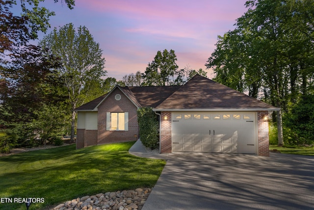 407 Tecumseh Pt, Loudon, TN 37774 - single story home featuring brick siding, driveway, a yard, and a garage