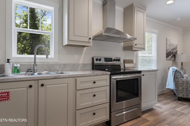 743 Pollard Rd, Kodak, TN 37764 - kitchen featuring wall chimney exhaust hood, stainless steel electric range oven, white cabinets, light countertops, and crown molding