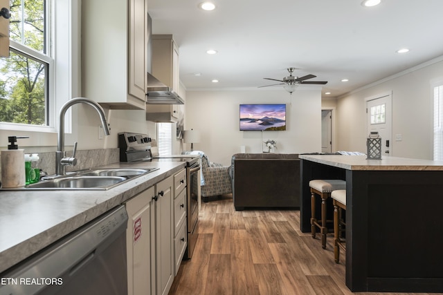 743 Pollard Rd, Kodak, TN 37764 - kitchen featuring stainless steel appliances, wood finished floors, a kitchen breakfast bar, recessed lighting, and ornamental molding