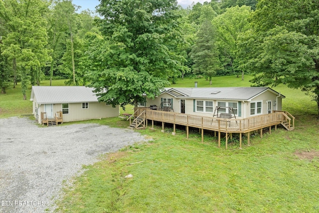 938 Riley Creek Rd, Whitleyville, TN 38588 - rear view of house with metal roof and a wooden deck