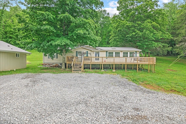 938 Riley Creek Rd, Whitleyville, TN 38588 - view of front facade with a deck, a front yard, and metal roof