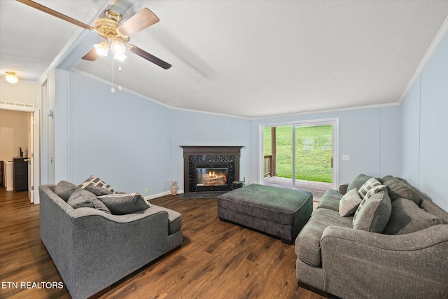 938 Riley Creek Rd, Whitleyville, TN 38588 - living room featuring crown molding, ceiling fan, a fireplace, wood finished floors, and a textured ceiling