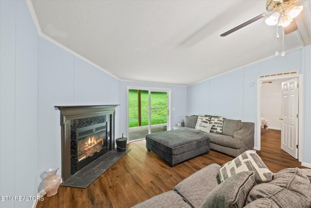 938 Riley Creek Rd, Whitleyville, TN 38588 - living room with lofted ceiling, ornamental molding, wood finished floors, ceiling fan, and a high end fireplace