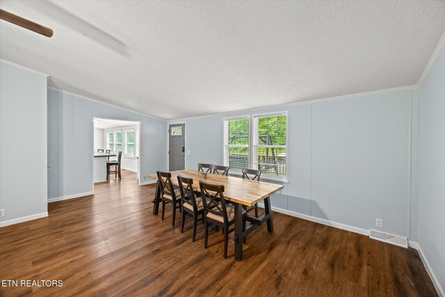 938 Riley Creek Rd, Whitleyville, TN 38588 - dining room featuring a textured ceiling, vaulted ceiling, wood finished floors, baseboards, and crown molding