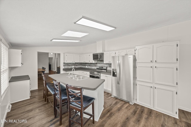 938 Riley Creek Rd, Whitleyville, TN 38588 - kitchen featuring appliances with stainless steel finishes, a sink, white cabinetry, dark wood finished floors, and a textured ceiling