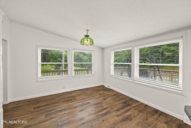 938 Riley Creek Rd, Whitleyville, TN 38588 - unfurnished room featuring a textured ceiling, dark wood finished floors, vaulted ceiling, and baseboards