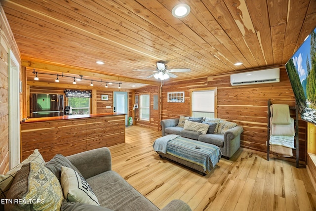 938 Riley Creek Rd, Whitleyville, TN 38588 - living area featuring rail lighting, wooden ceiling, a wall mounted AC, wooden walls, and light wood-style flooring