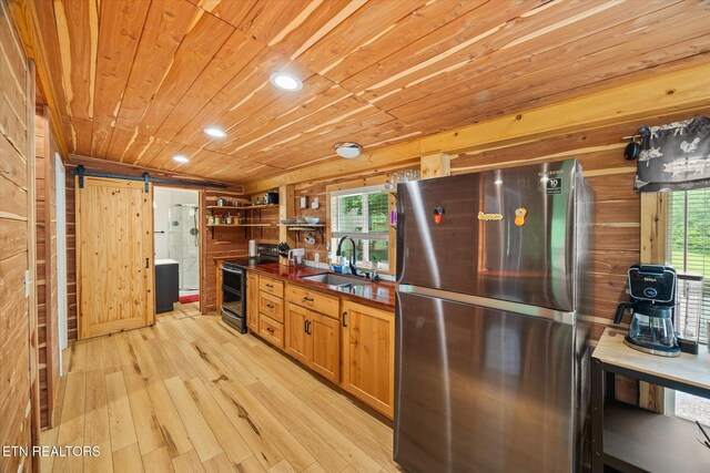 938 Riley Creek Rd, Whitleyville, TN 38588 - kitchen with appliances with stainless steel finishes, a sink, a barn door, wood ceiling, and dark countertops