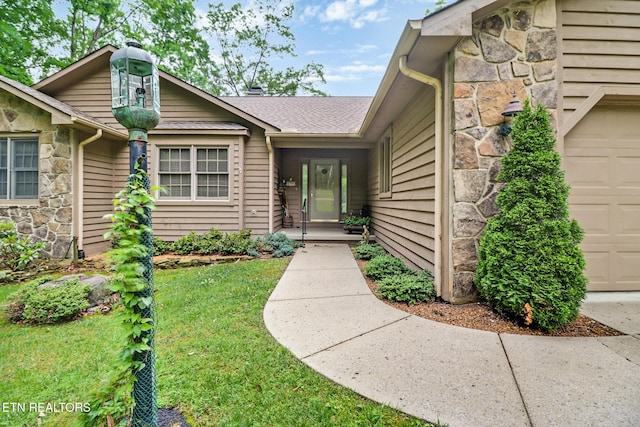 45 Calderwood Cir, Fairfield Glade, TN 38558 - view of exterior entry featuring stone siding, an attached garage, and a yard