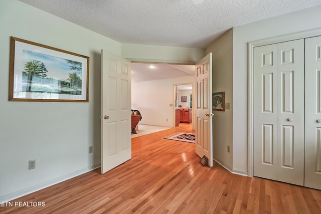 45 Calderwood Cir, Fairfield Glade, TN 38558 - hall featuring light wood-style flooring, a textured ceiling, and baseboards