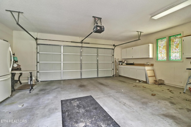 45 Calderwood Cir, Fairfield Glade, TN 38558 - garage with a garage door opener and freestanding refrigerator