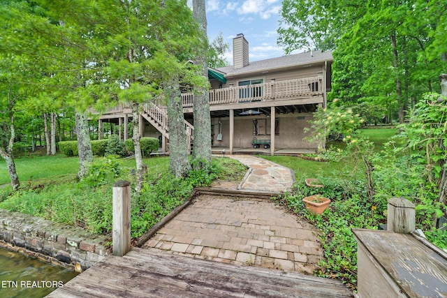 45 Calderwood Cir, Fairfield Glade, TN 38558 - back of property featuring a wooden deck, a chimney, a patio, stairs, and a lawn