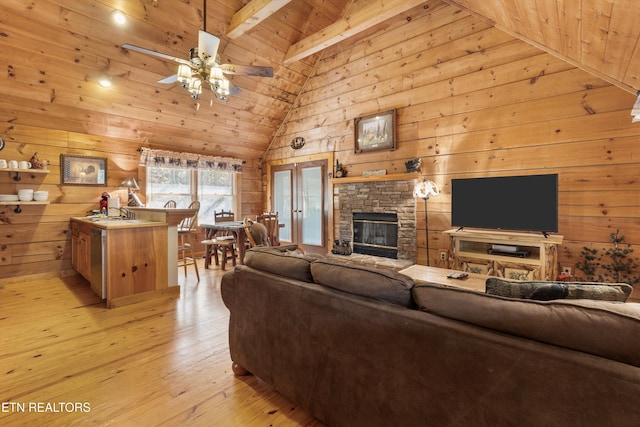 214 Tsali Way, Sevierville, TN 37876 - living area featuring wooden ceiling with exposed beams, wood walls, light wood-type flooring, high vaulted ceiling, and a ceiling fan