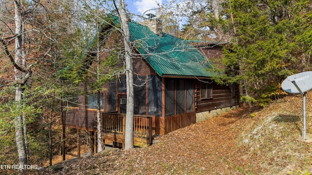 214 Tsali Way, Sevierville, TN 37876 - view of home's exterior with metal roof, a sunroom, and a chimney