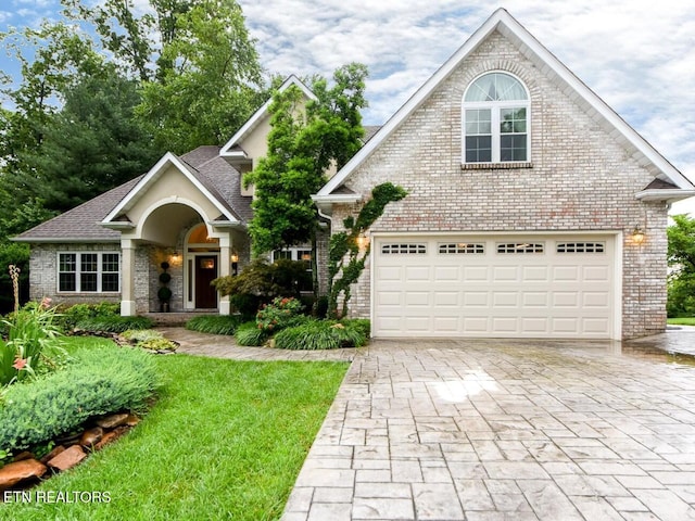 716 Devictor Dr, Maryville, TN 37801 - traditional-style house with a garage, decorative driveway, a front yard, and brick siding
