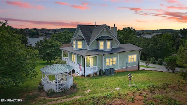 309 Southshore Dr, Greenback, TN 37742 - back of property at dusk with a chimney, a porch, a lawn, and central AC unit