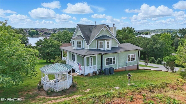 309 Southshore Dr, Greenback, TN 37742 - rear view of house with a chimney, a porch, a yard, central AC, and a water view