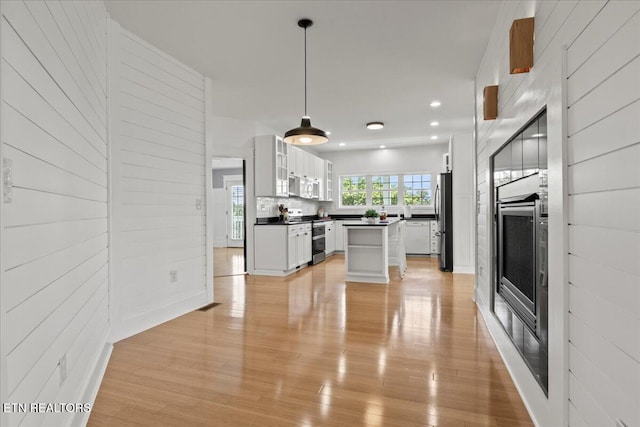 309 Southshore Dr, Greenback, TN 37742 - kitchen with stainless steel appliances, dark countertops, white cabinets, light wood-style flooring, and recessed lighting