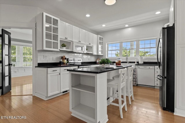 309 Southshore Dr, Greenback, TN 37742 - kitchen with stainless steel appliances, open shelves, light wood-style flooring, and recessed lighting