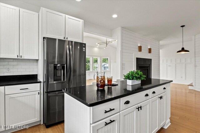 309 Southshore Dr, Greenback, TN 37742 - kitchen featuring stainless steel fridge with ice dispenser, white cabinets, light wood-style floors, open floor plan, and tasteful backsplash