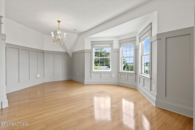 309 Southshore Dr, Greenback, TN 37742 - spare room with a decorative wall, a chandelier, light wood-type flooring, and wainscoting