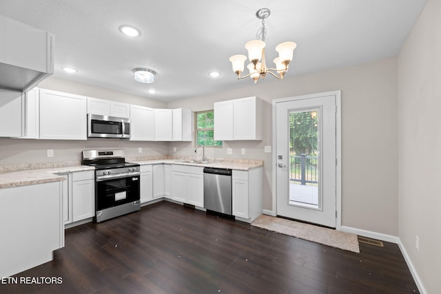 109 Ivy Ln, Oak Ridge, TN 37830 - kitchen featuring stainless steel appliances, a chandelier, white cabinets, dark wood-style floors, and recessed lighting