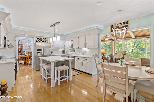 109 Cheeskogili Way, Loudon, TN 37774 - kitchen featuring stainless steel appliances, a center island, a sink, light countertops, and white cabinetry