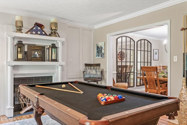 109 Cheeskogili Way, Loudon, TN 37774 - recreation room featuring billiards, ornamental molding, wood finished floors, a fireplace, and a textured ceiling