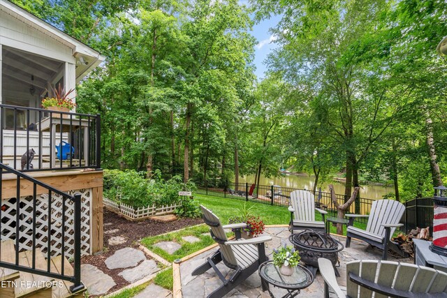 109 Cheeskogili Way, Loudon, TN 37774 - view of patio featuring an outdoor fire pit, view of scattered trees, a vegetable garden, and a water view