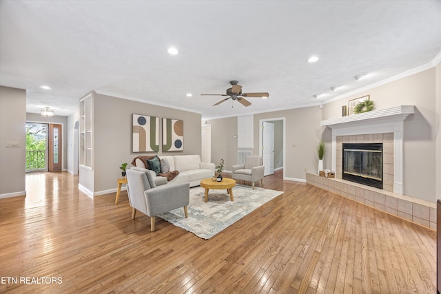 11514 Dobe Way, Knoxville, TN 37932 - living room featuring light wood-style floors, a tile fireplace, recessed lighting, ornamental molding, and baseboards