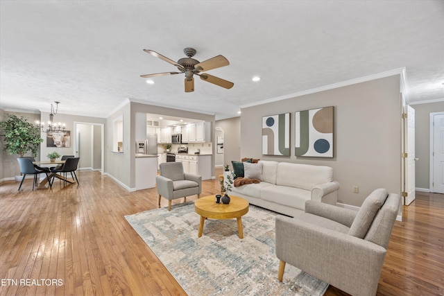11514 Dobe Way, Knoxville, TN 37932 - living room with a chandelier, light wood-type flooring, baseboards, crown molding, and a ceiling fan