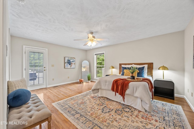 11514 Dobe Way, Knoxville, TN 37932 - bedroom featuring access to exterior, baseboards, wood finished floors, a textured ceiling, and ceiling fan