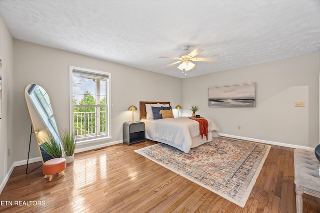 11514 Dobe Way, Knoxville, TN 37932 - bedroom with wood-type flooring, baseboards, a textured ceiling, and a ceiling fan