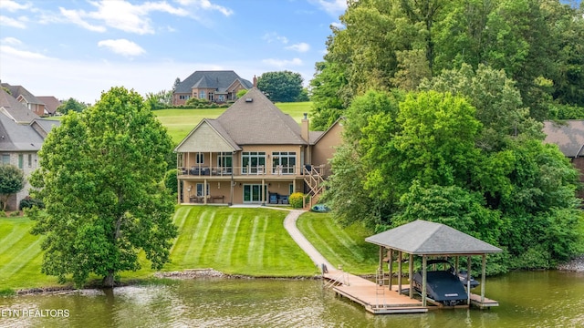 325 Pineberry Dr, Vonore, TN 37885 - back of house featuring boat lift, a water view, a lawn, and stucco siding