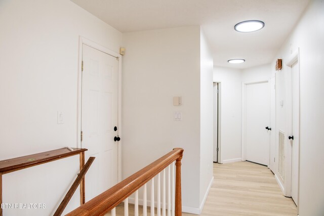 422 Willow Tree Ln, Morristown, TN 37814 - hallway featuring light wood-type flooring and an upstairs landing