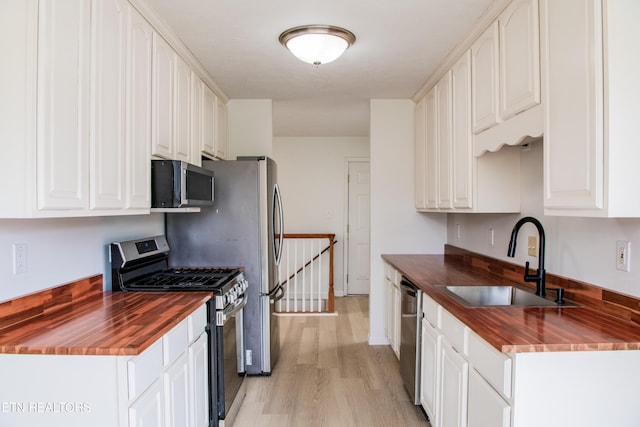 422 Willow Tree Ln, Morristown, TN 37814 - kitchen with wood counters, appliances with stainless steel finishes, light wood-type flooring, and white cabinets