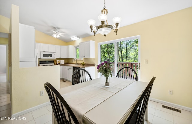 635 Gold Dust Dr, Pigeon Forge, TN 37863 - dining area with a chandelier, a ceiling fan, lofted ceiling, light tile patterned flooring, and baseboards